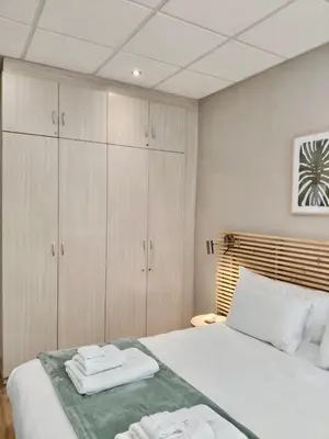 a bedroom with a bed with two towels on it at The Botanic High Gold in Paarl
