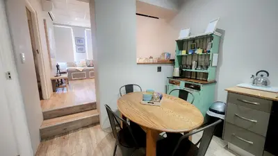 a small kitchen with a wooden table in a room at The Botanic High Gold in Paarl