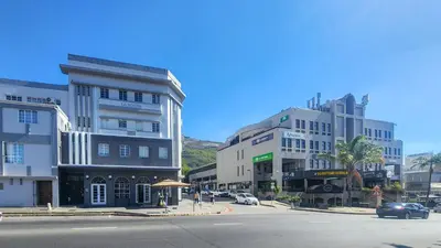 a city street with tall buildings and a street with cars at The Botanic High Gold in Paarl