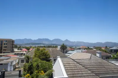 a view of roofs of houses in a city at Mountain View Coastal Retreat in Strand