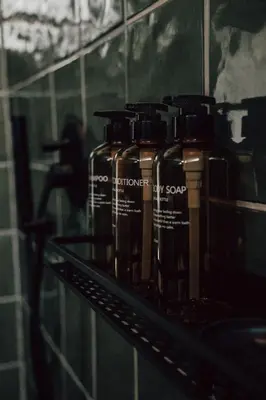 a row of bottles of soap sitting on a shelf at The Crescent Hideaway in Franschhoek
