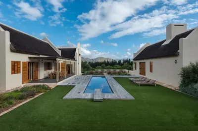 an image of a backyard with a pool and grass at Skaap huis in Sir Lowryʼs Pass