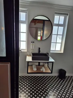 a bathroom with a black sink and a mirror at Paarl Boutique Hotel in Paarl