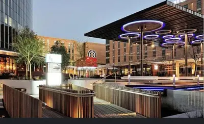 a building with a sign on the side of it at Luxe at Nine Palms Near Canal Walk in Cape Town