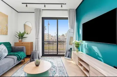 a living room with a couch and a flat screen tv at Luxe at Nine Palms Near Canal Walk in Cape Town