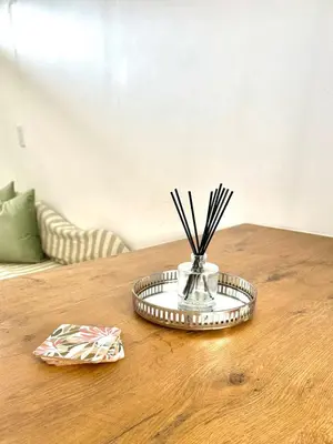 a table with a silver tray with sticks in it at Lalla Cottages - Cape Town in Cape Town