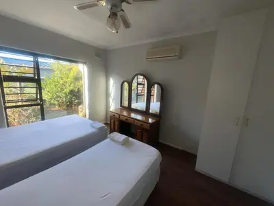 a bedroom with a bed and a desk and a window at triplediz in Blackheath