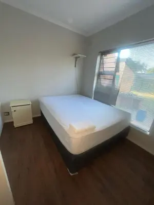 a bedroom with a large bed in a room with a window at triplediz in Blackheath