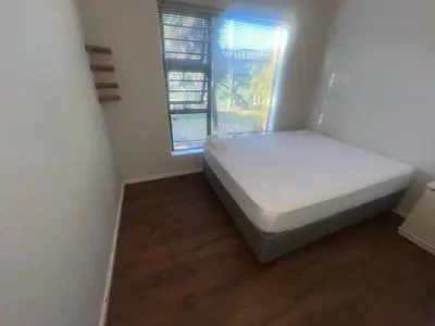 a small bedroom with a bed and a window at triplediz in Blackheath