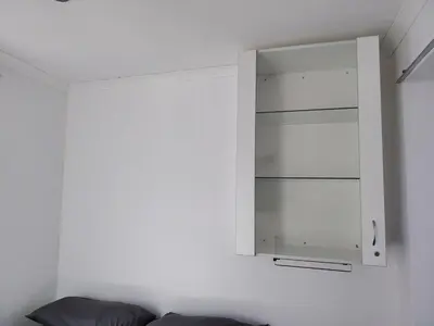 a white cabinet in a room with a couch at Kenwyn Micro Apartments 2 in Cape Town