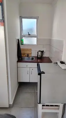 a small kitchen with a sink and a window at Kenwyn Micro Apartments 2 in Cape Town