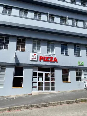 a white building with a pizza sign on it at Salt & Cellar - Paarl - Self Catering Apartment in Paarl