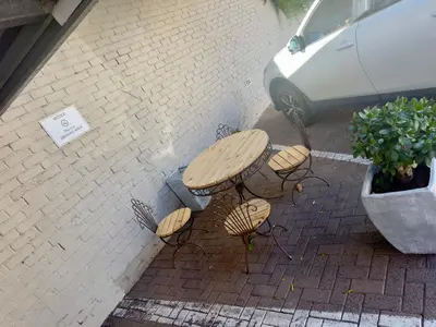 a picnic table and benches on a brick sidewalk at Salt & Cellar - Paarl - Self Catering Apartment in Paarl