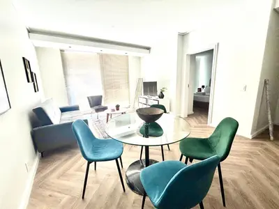 a living room with a table and chairs and a couch at Modern Luxe On Park in Cape Town