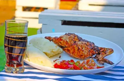 a plate of food and a drink on a table at Guided Tour of Belhar South Africa in Belhar