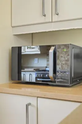 a microwave sitting on a counter in a kitchen at Spacious Claremont Home with Pool Fireplace in Cape Town