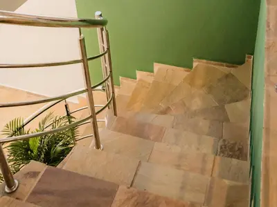 a wooden staircase with a metal rail and a green wall at Cape Joy - BRAND NEW luxury villa just rolled out in Cape Town, Plattekloof in Plattekloof