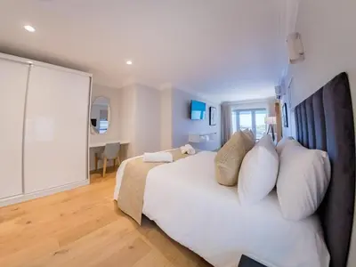 a bedroom with a large white bed with pillows at Cape Joy - BRAND NEW luxury villa just rolled out in Cape Town, Plattekloof in Plattekloof