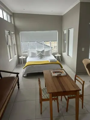 a bedroom with a bed and a wooden table at 16Park in Stikland