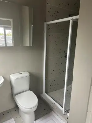 a bathroom with a toilet and a walk in shower at 16Park in Stikland
