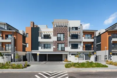 an empty parking lot in front of a building at Breeze of the Sea Apartment in Cape Town