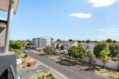 a street view from the balcony of a apartment at Breeze of the Sea Apartment in Cape Town