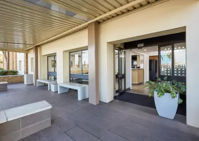 a lobby with benches and windows on a building at SUN1 Parow Cape Town in Avondale