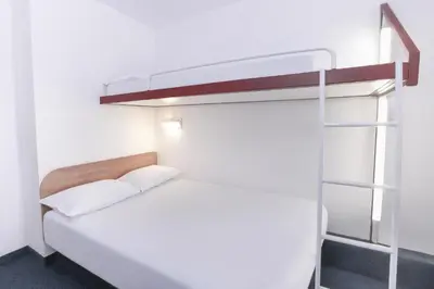 a bedroom with a bunk bed with a ladder at SUN1 Parow Cape Town in Avondale