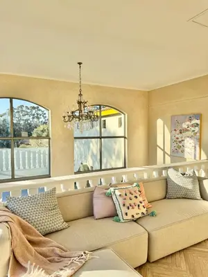a living room with a couch and windows at Grande Casa - Central Stellenbosch in Stellenbosch