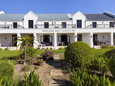 a white building with a sign that reads merganser cuttings court house at Winelands Golf Lodges 1 in Onder-Papegaaiberg