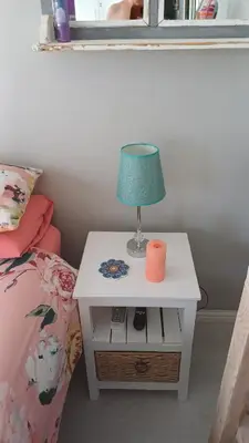 a lamp on a night stand next to a bed at Sozo - our place at the ocean in Gordonʼs Bay