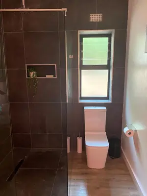 a bathroom with a toilet and a window at Modern, Comfy Guest Suite with Beautiful Views in Welgemoed in Tygerberg Hills
