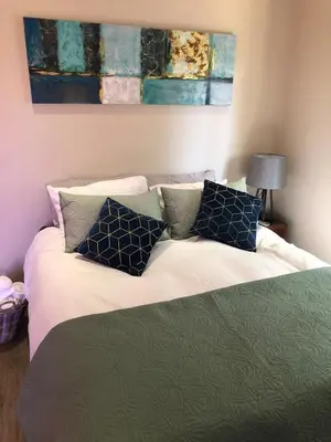 a bedroom with a bed with pillows on it at Modern, Comfy Guest Suite with Beautiful Views in Welgemoed in Tygerberg Hills
