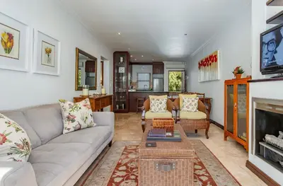 a living room with a couch and a fireplace at Holly Tree Franschhoek Accommodation in Franschhoek