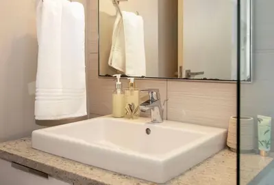 a white sink in a bathroom with a mirror at Stay at Andringa Walk Luxury Apartment in Stellenbosch