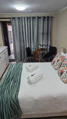 a bedroom with a large bed with two towels on it at Victoria's Rest in Windsor Park