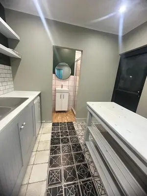 a kitchen with a counter and a tile floor at 29Windsor in Silver Sands