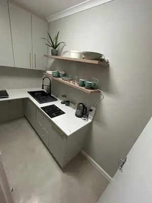 a kitchen with a sink and a stove in it at The Peaceful Nook Somerset 2 in Somerset West