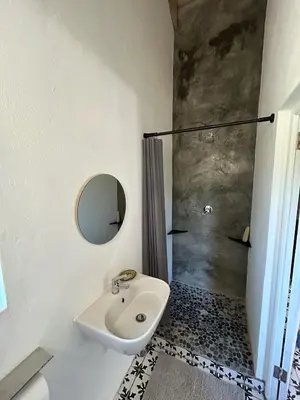 a bathroom with a sink and a shower at Garden Studio in Greyton