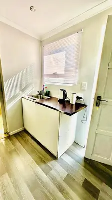 a kitchen with a counter with a sink and a window at Hideaway Haven 2 in Cape Town