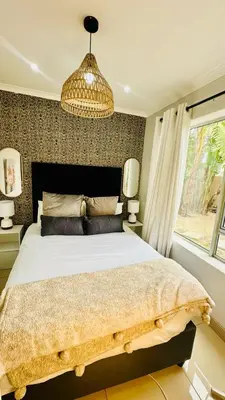 a bedroom with a large bed and a window at Hideaway Haven 2 in Cape Town
