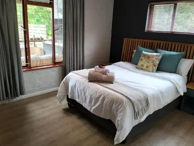 a bedroom with a bed with a stuffed animal on it at Dawson78 in Hermanus