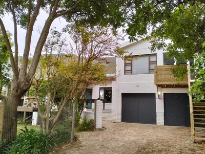 a white house with two garage doors at Dawson78 in Hermanus