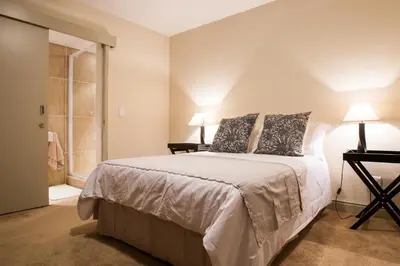 a bedroom with a bed with two pillows on it at Loddey's Self Catering Apartments - by Beach Collection in Strand