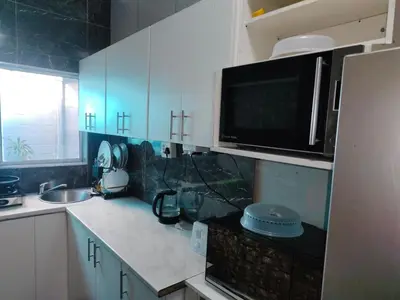 a kitchen with a sink and a microwave at Boblodge in Cape Town