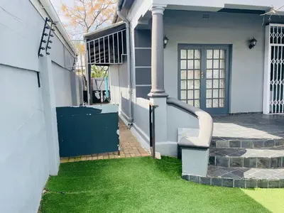 a front door of a house with green grass at ANNIKA B&B Claremont in Cape Town