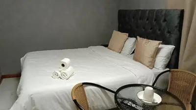 a bed with two rolls of toilet paper on it at Spring forth guest house in De Grendel