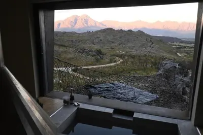 a large window with a view of a mountain at Skaam Cabin Luxe Hideaway with a Naughty Side in Wolseley