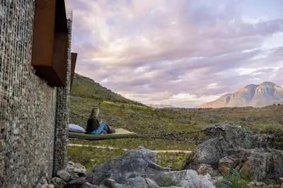 two people sitting on a raft in the mountains at Skaam Cabin Luxe Hideaway with a Naughty Side in Wolseley