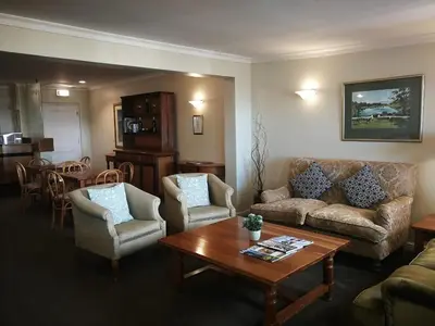 a living room with a couch and chairs and a table at Zevenwacht Cottages in Kuilsrivier